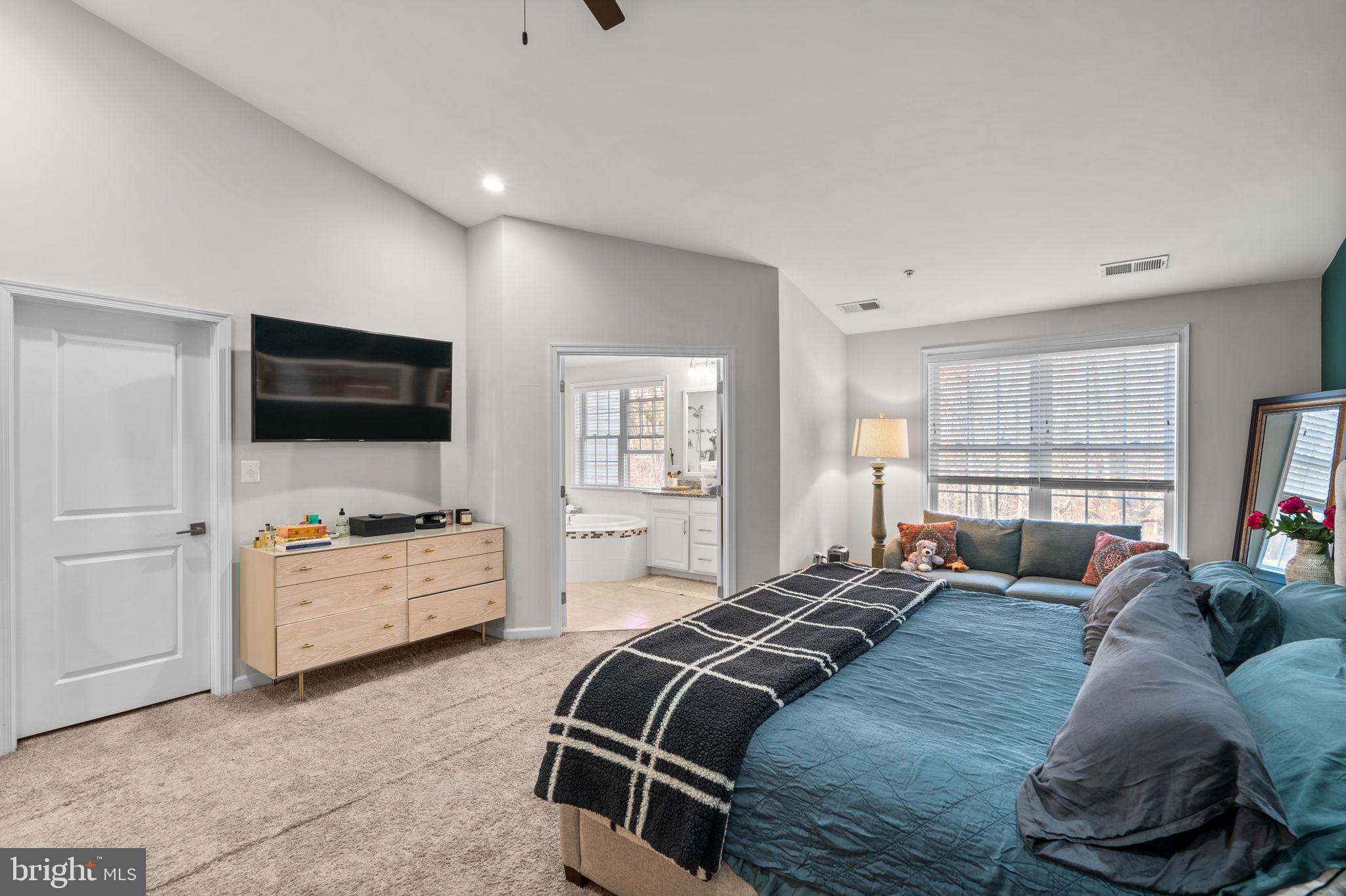 4323 Spring Foal Court Upper Marlboro, MD 20772 - Photo 25 of 49 a large bedroom with a bed and flat screen tv