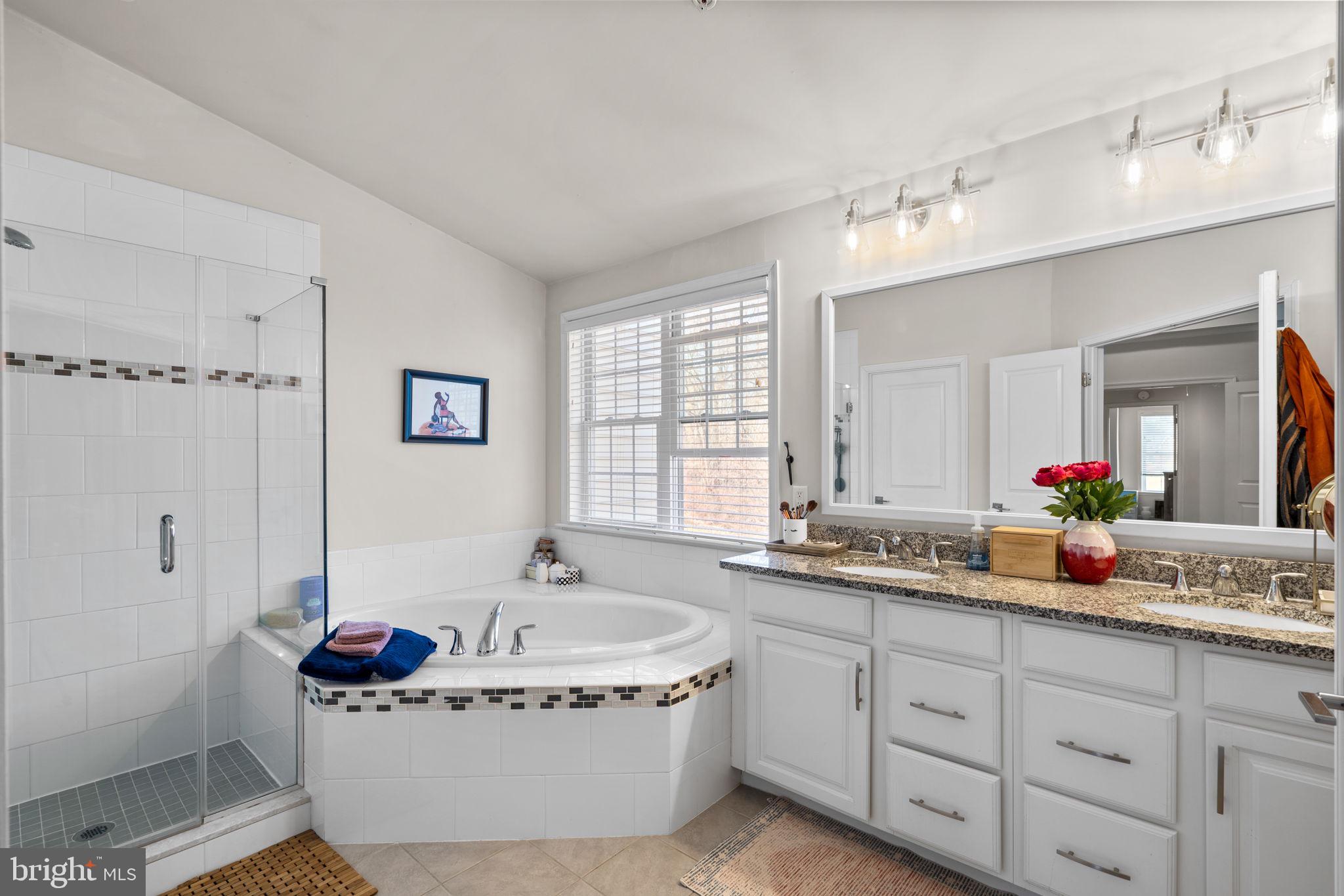 4323 Spring Foal Court Upper Marlboro, MD 20772 - Photo 26 of 49 a spacious bathroom with a tub sink and mirror