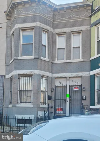 a front view of a brick building with a entrance