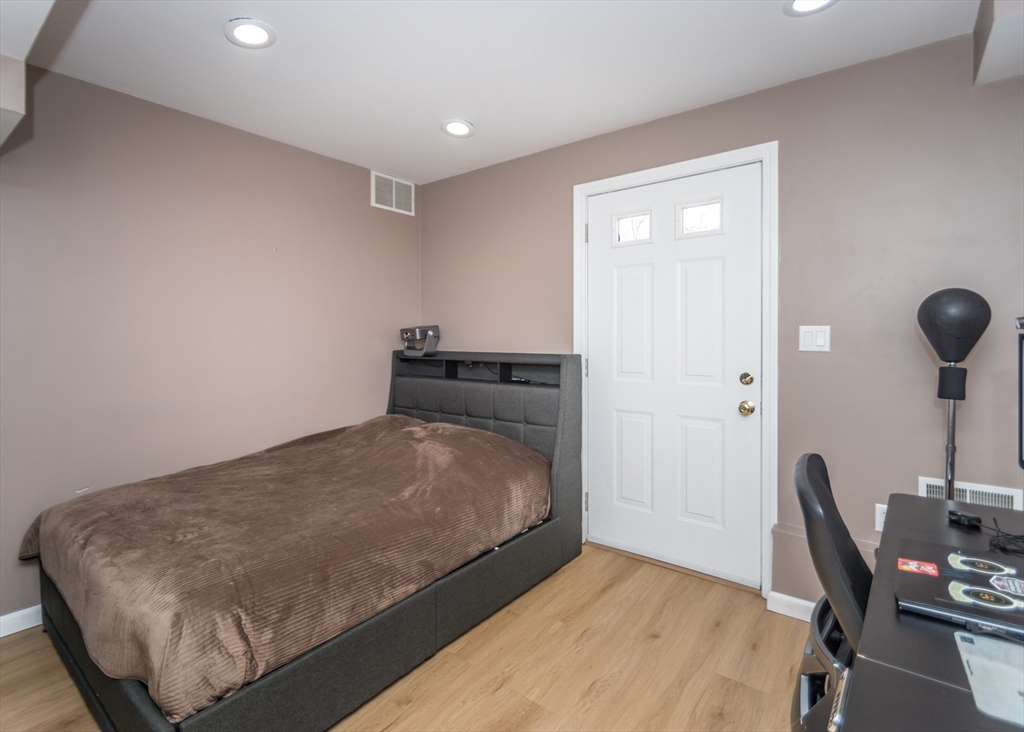 985 Trapelo Road, Unit 23 Waltham, MA 02452 - Photo 22 of 27 a bedroom with a bed and a desk