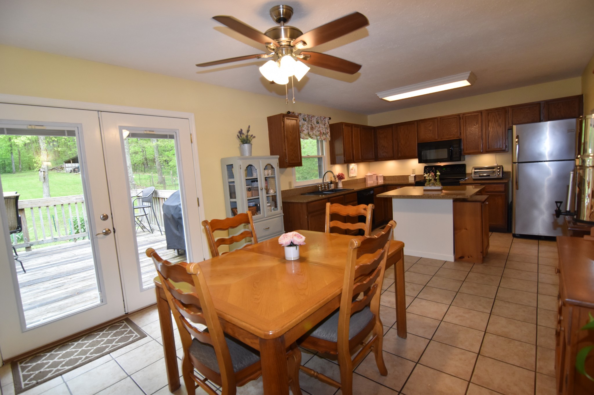 2513 Quarry Road Mount Juliet, TN 37122 - Photo 14 of 42 a dining room with stainless steel appliances kitchen island granite countertop a table chairs and a refrigerator
