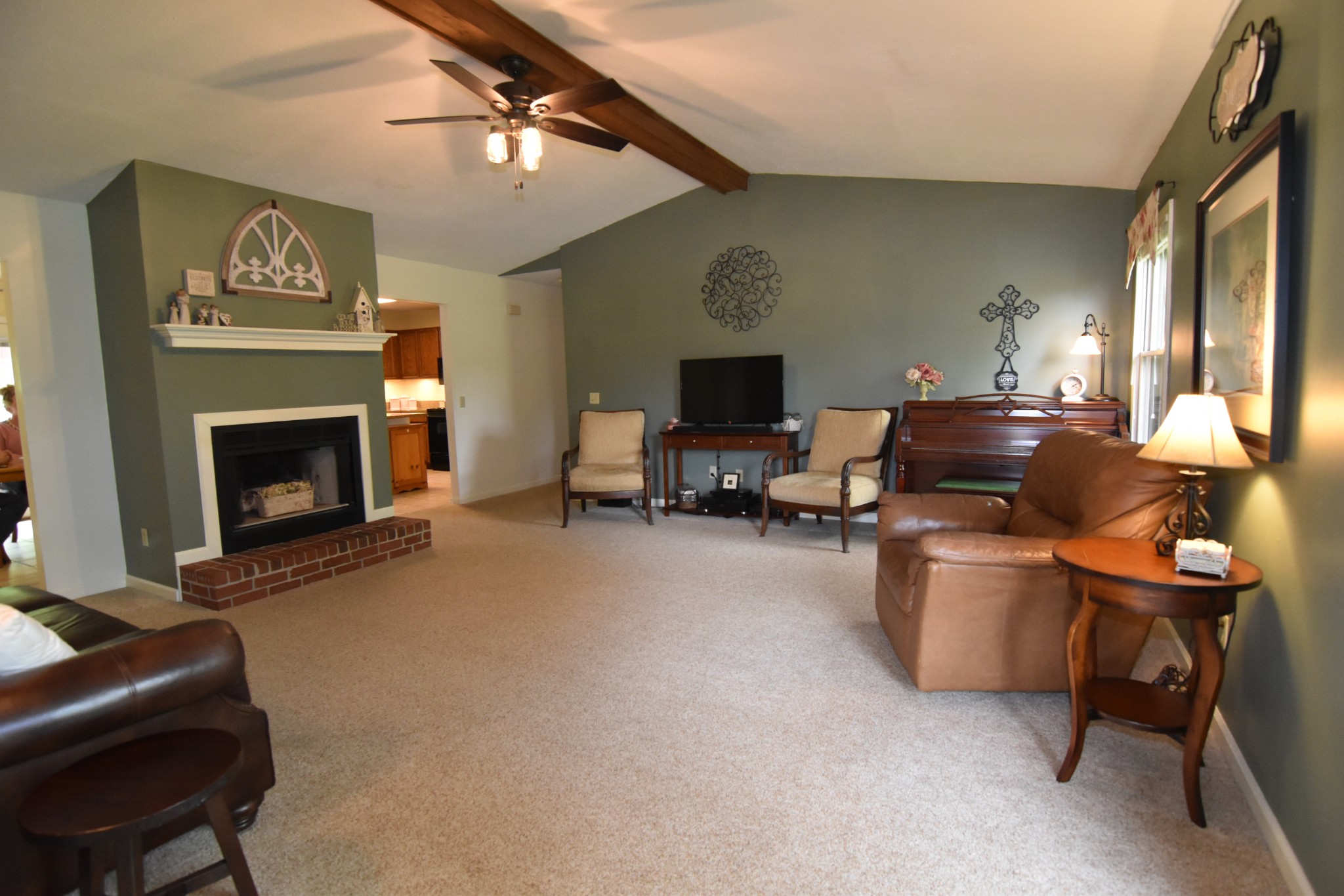 2513 Quarry Road Mount Juliet, TN 37122 - Photo 7 of 42 a living room with furniture a fireplace and a flat screen tv