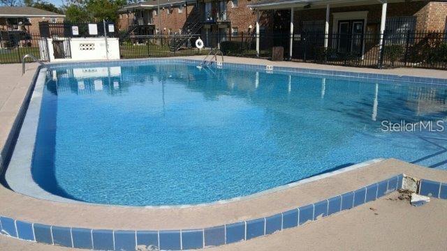 5317 Curry Ford Road, Unit 103 Orlando, FL 32812 - Photo 3 of 10 a view of a swimming pool with a patio