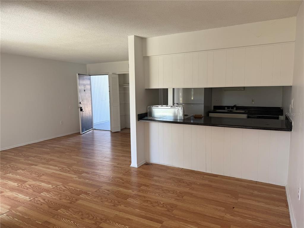 5317 Curry Ford Road, Unit 103 Orlando, FL 32812 - Photo 9 of 10 a kitchen with stainless steel appliances a sink and a stove top oven