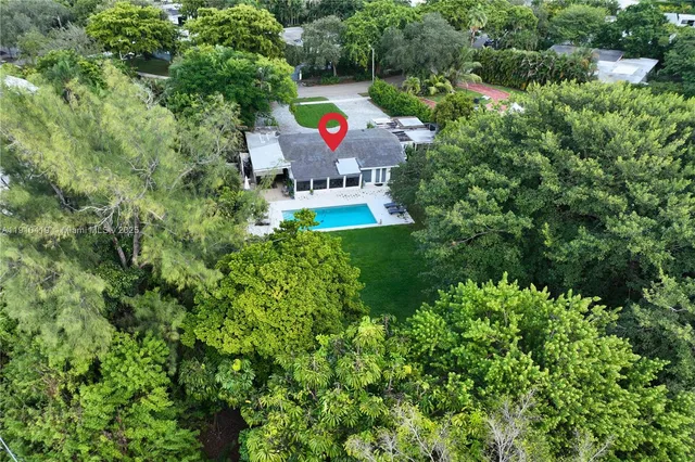 an aerial view of house with yard and outdoor seating