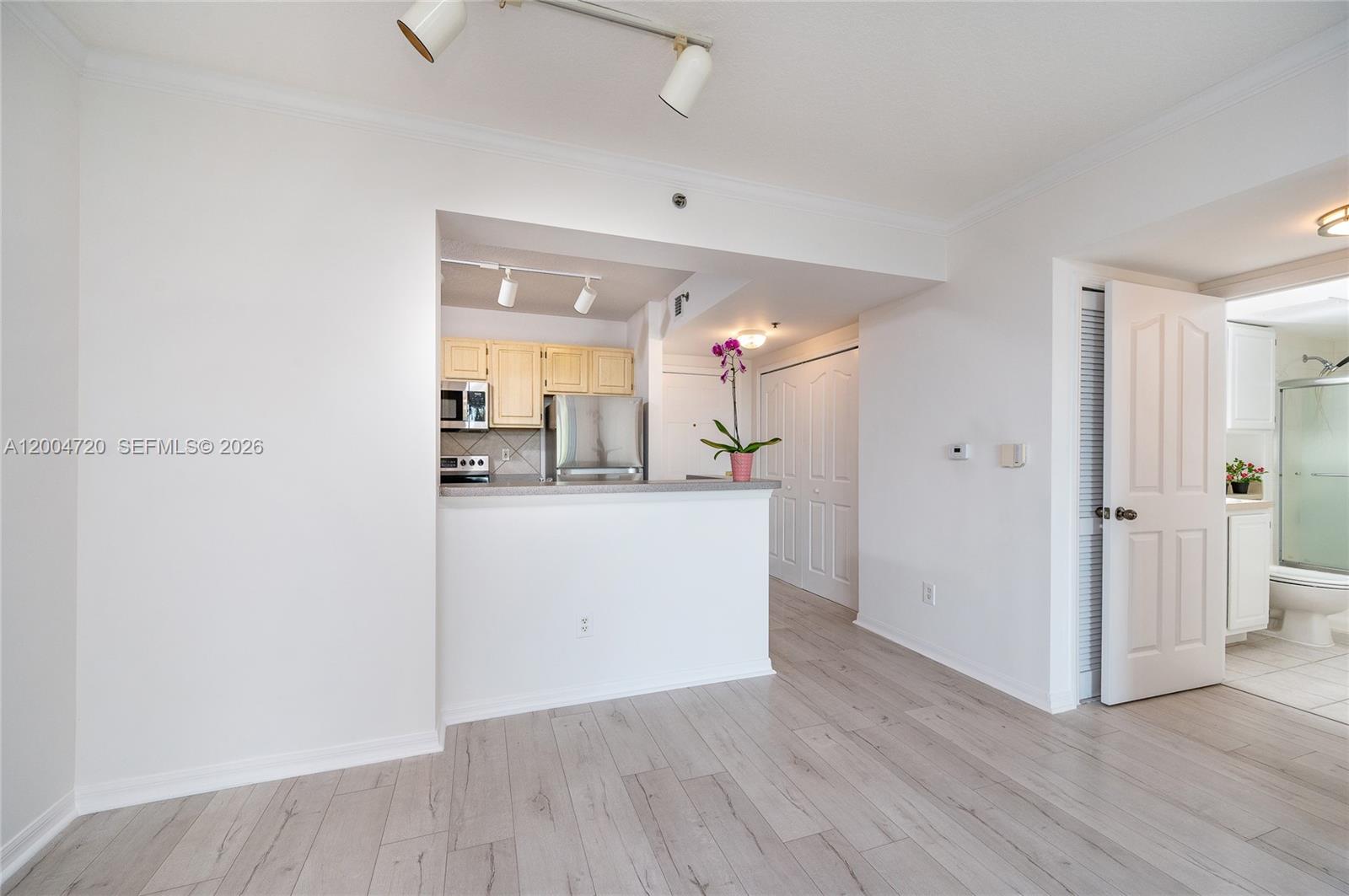 2665 Southwest 37th Avenue, Unit 201 Miami, FL 33133 - Photo 11 of 33 a view of a hallway with wooden floor and a living room