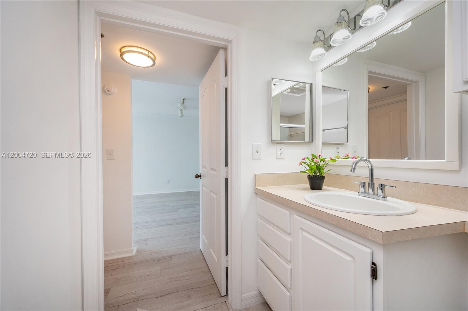 2665 Southwest 37th Avenue, Unit 201 Miami, FL 33133 - Photo 21 of 33 a bathroom with a sink and a mirror