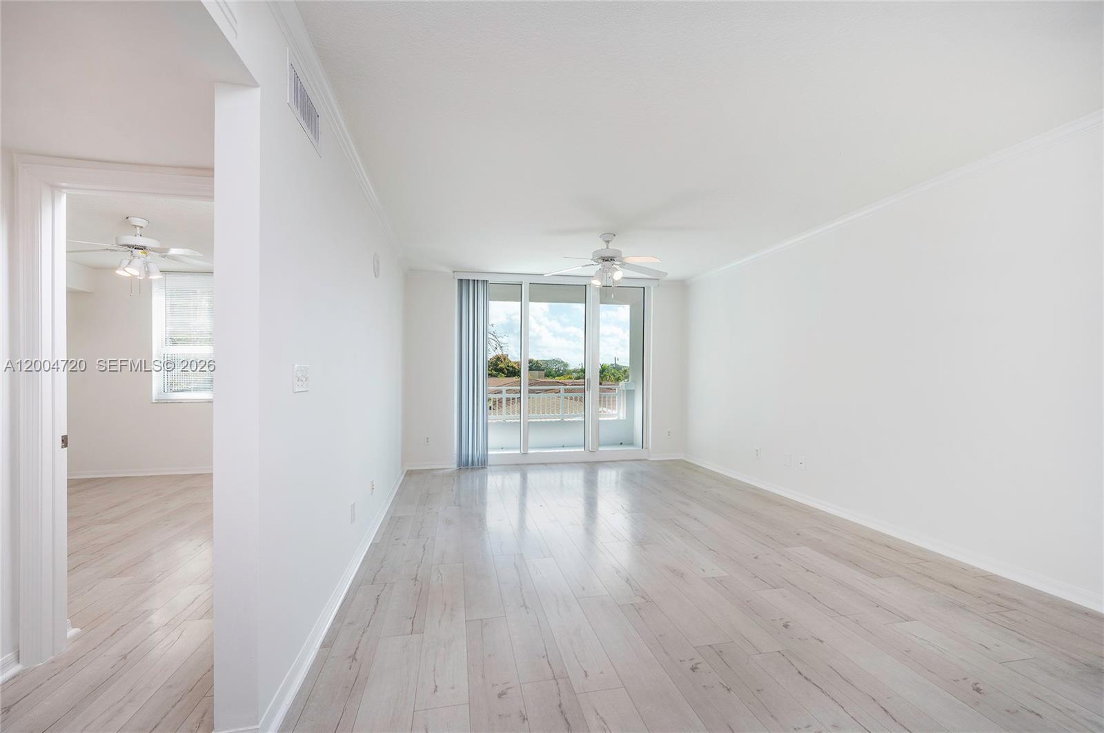 2665 Southwest 37th Avenue, Unit 201 Miami, FL 33133 - Photo 6 of 33 wooden floor in an empty room with a window
