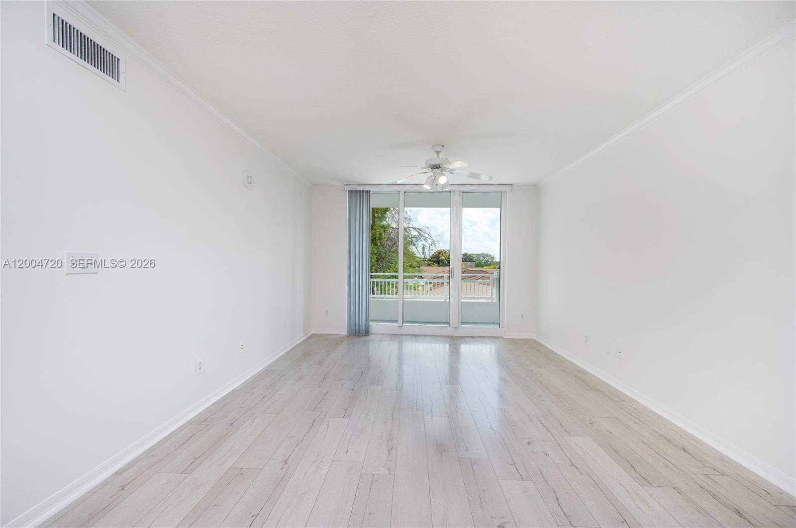 2665 Southwest 37th Avenue, Unit 201 Miami, FL 33133 - Photo 7 of 33 a view of an empty room with wooden floor and a window
