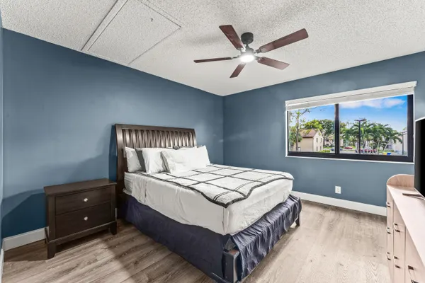 a bedroom with a large bed and a window