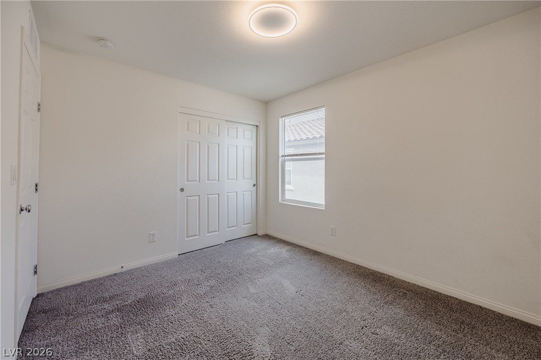5927 Coja Street Las Vegas, NV 89113 - Photo 23 of 32 Unfurnished bedroom featuring carpet floors, baseboards, and a closet