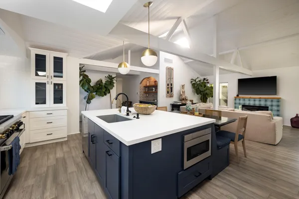 a large kitchen with stainless steel appliances a stove oven and a fireplace