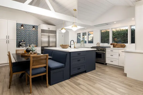a kitchen with a sink stove and wooden cabinets