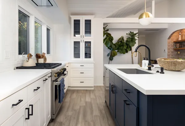 a kitchen with a sink stove and cabinets