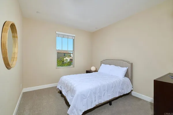 a bedroom with a bed and a mirror
