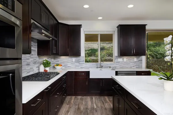 a kitchen with a sink stove and microwave