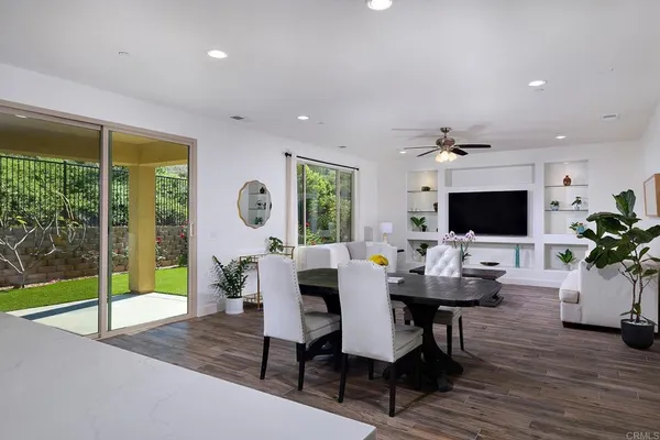 a view of a dining room with furniture window and wooden floor