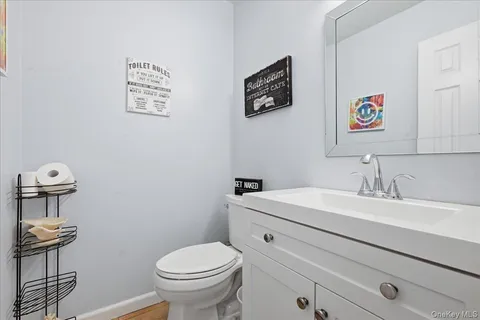 a bathroom with a toilet a sink and mirror