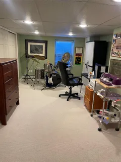 a room with furniture gym equipment and a flat screen tv