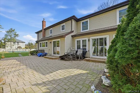 a view of a house with backyard sitting area and garden