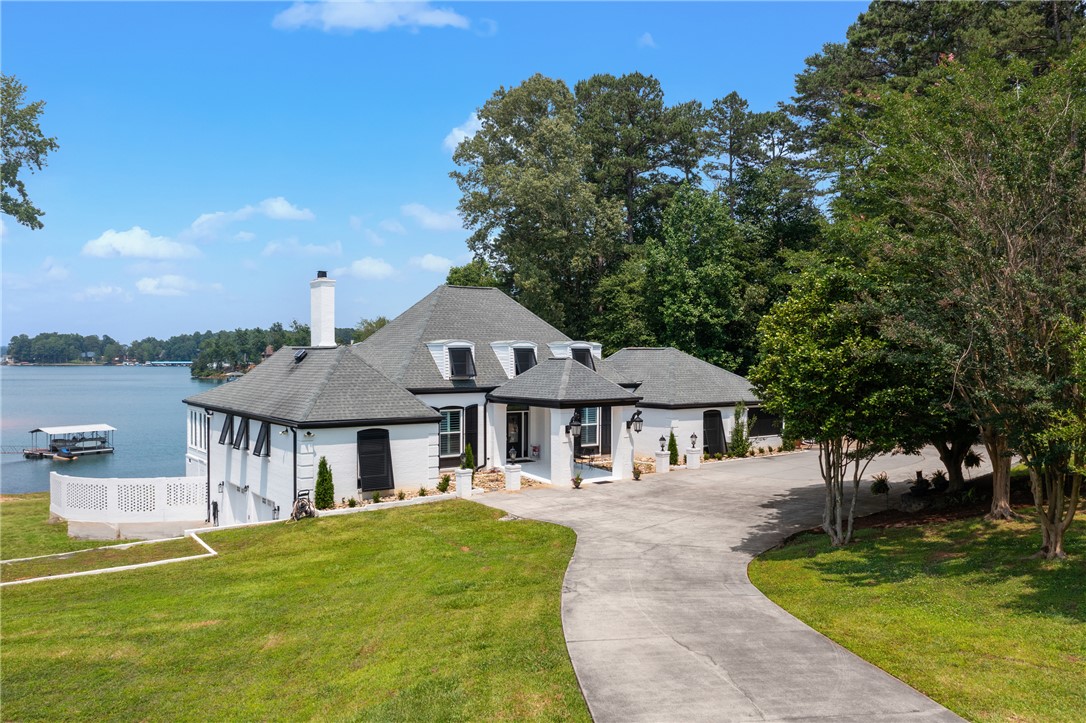 A rare and refined offering on Lake Keowee—this unrestricted 4BR, 4.5BA waterfront estate sits on an expansive 1.80-acre lot, just minutes from town yet wrapped in rural, lakeside privacy.