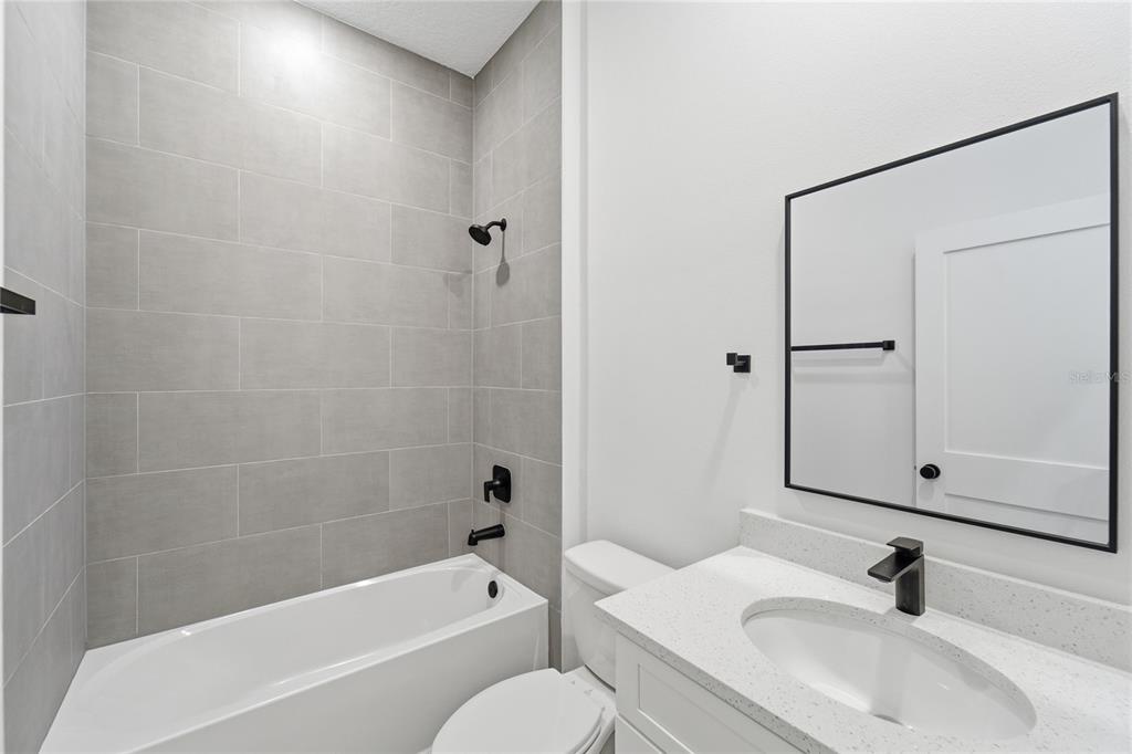 2600 Southwest 146th Pl Road Ocala, FL 34473 - Photo 9 of 40 a bathroom with a sink toilet and shower