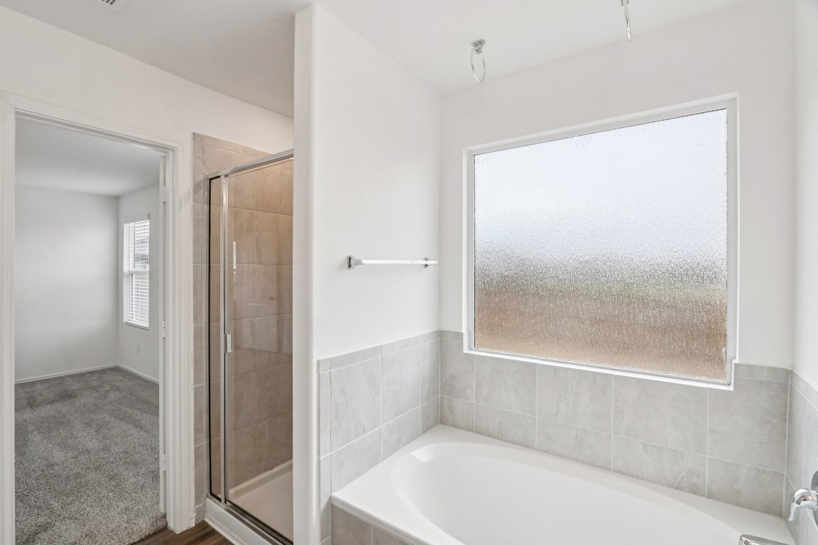 240 Line Of Fire Way Jarrell, TX 76537 - Photo 24 of 33 Full bathroom with a garden tub and a stall shower