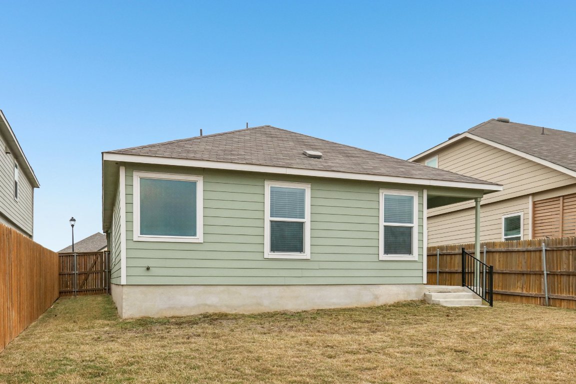 240 Line Of Fire Way Jarrell, TX 76537 - Photo 30 of 33 Rear view of property with roof with shingles and a fenced backyard