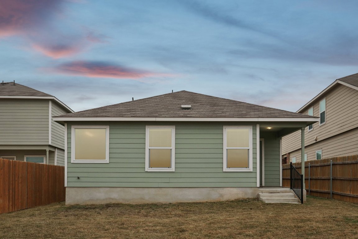 240 Line Of Fire Way Jarrell, TX 76537 - Photo 32 of 33 Back of property at dusk with a fenced backyard and roof with shingles