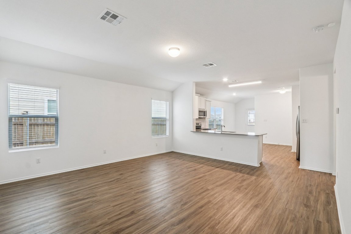 240 Line Of Fire Way Jarrell, TX 76537 - Photo 4 of 33 Unfurnished living room featuring LVP flooring