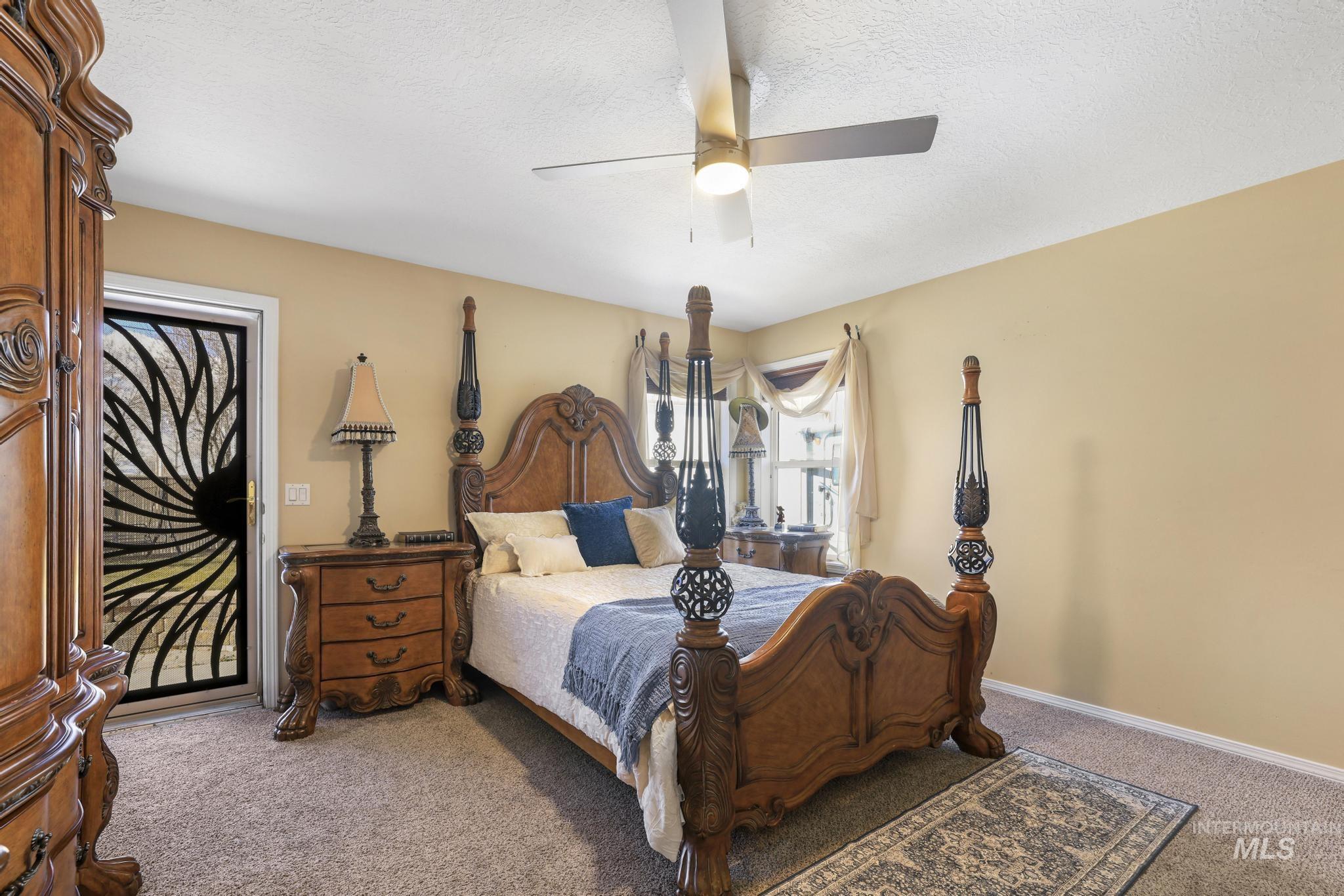 733 Beta Circle Twin Falls, ID 83301 - Photo 19 of 50 Bedroom featuring carpet, a ceiling fan, and a textured ceiling