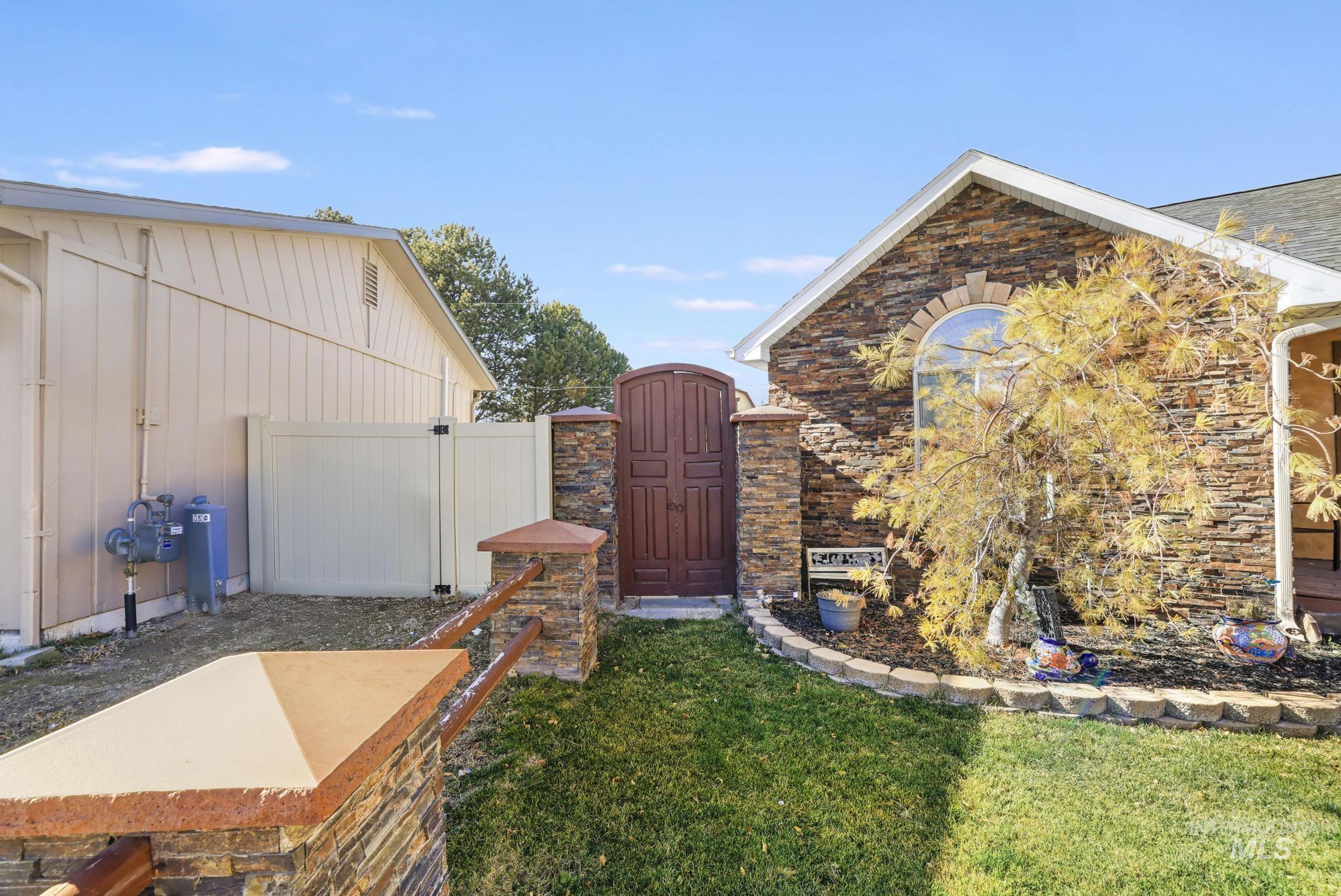 733 Beta Circle Twin Falls, ID 83301 - Photo 32 of 50 View of home's exterior with a gate and stone siding