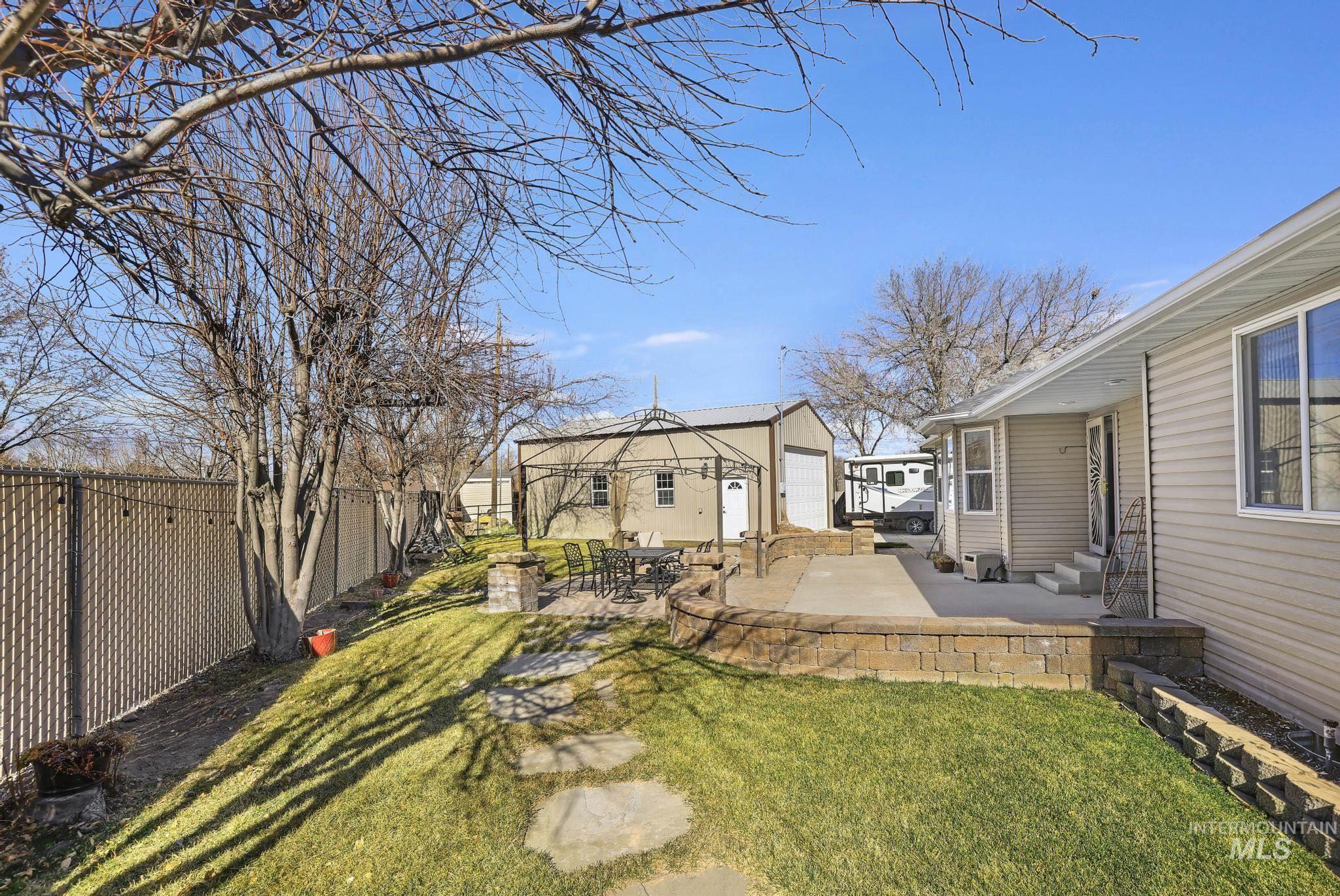 733 Beta Circle Twin Falls, ID 83301 - Photo 34 of 50 Fenced backyard with an outbuilding, a patio, and entry steps