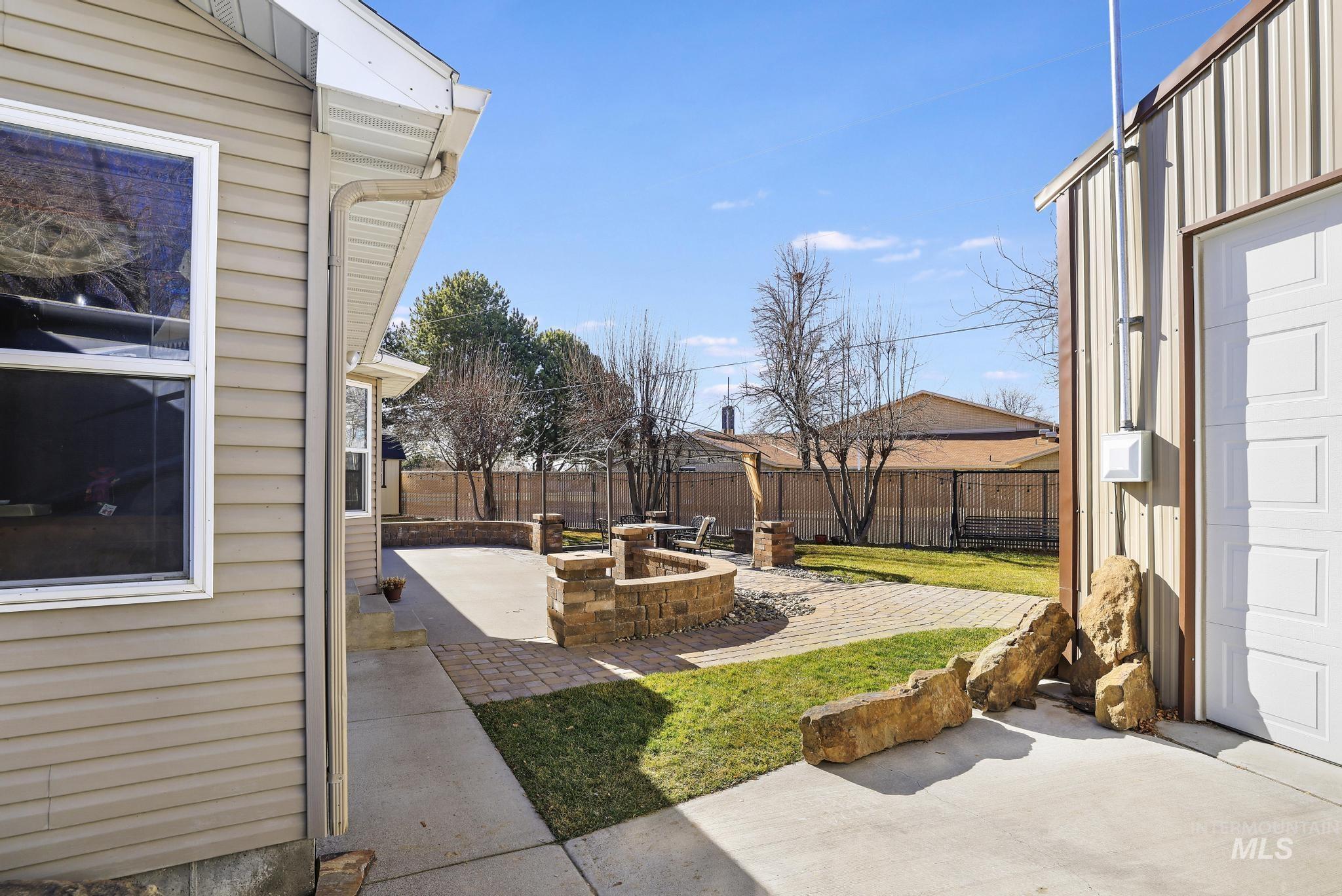 733 Beta Circle Twin Falls, ID 83301 - Photo 35 of 50 Fenced backyard featuring an outdoor fire pit and a patio area