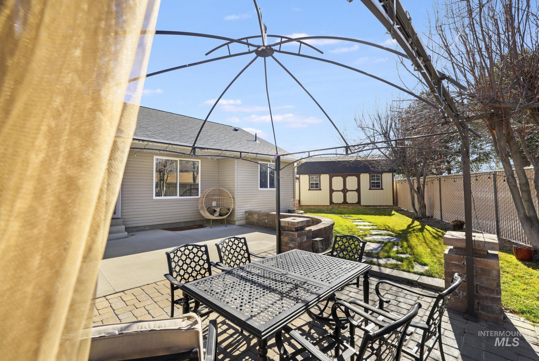 733 Beta Circle Twin Falls, ID 83301 - Photo 43 of 50 Fenced backyard with outdoor dining area, a patio area, and a shed