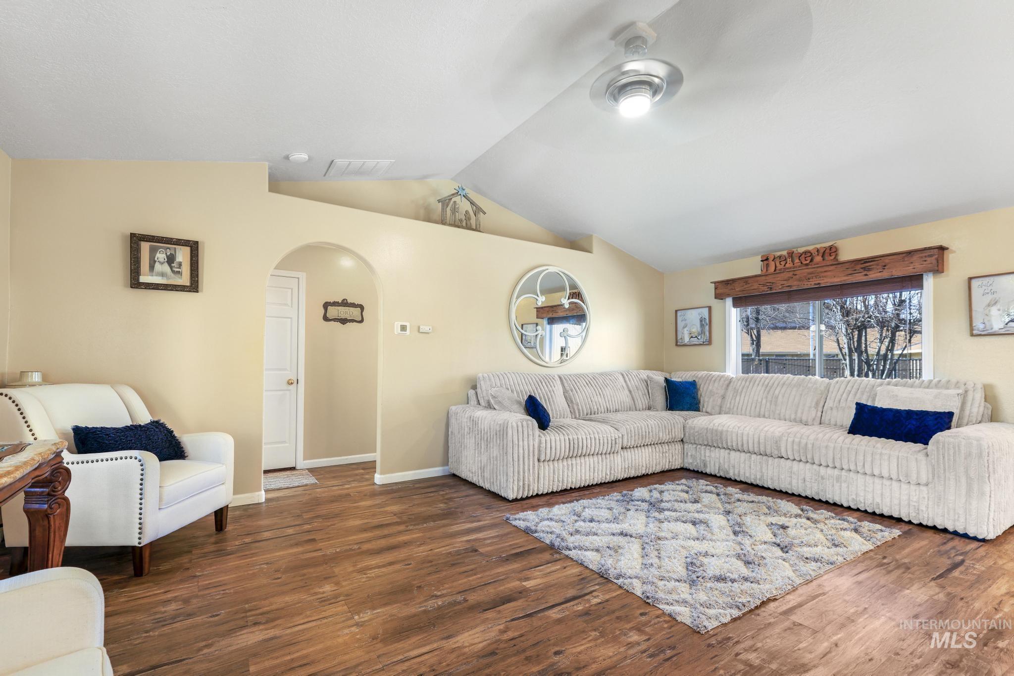 733 Beta Circle Twin Falls, ID 83301 - Photo 5 of 50 Living area featuring wood finished floors, arched walkways, and a ceiling fan