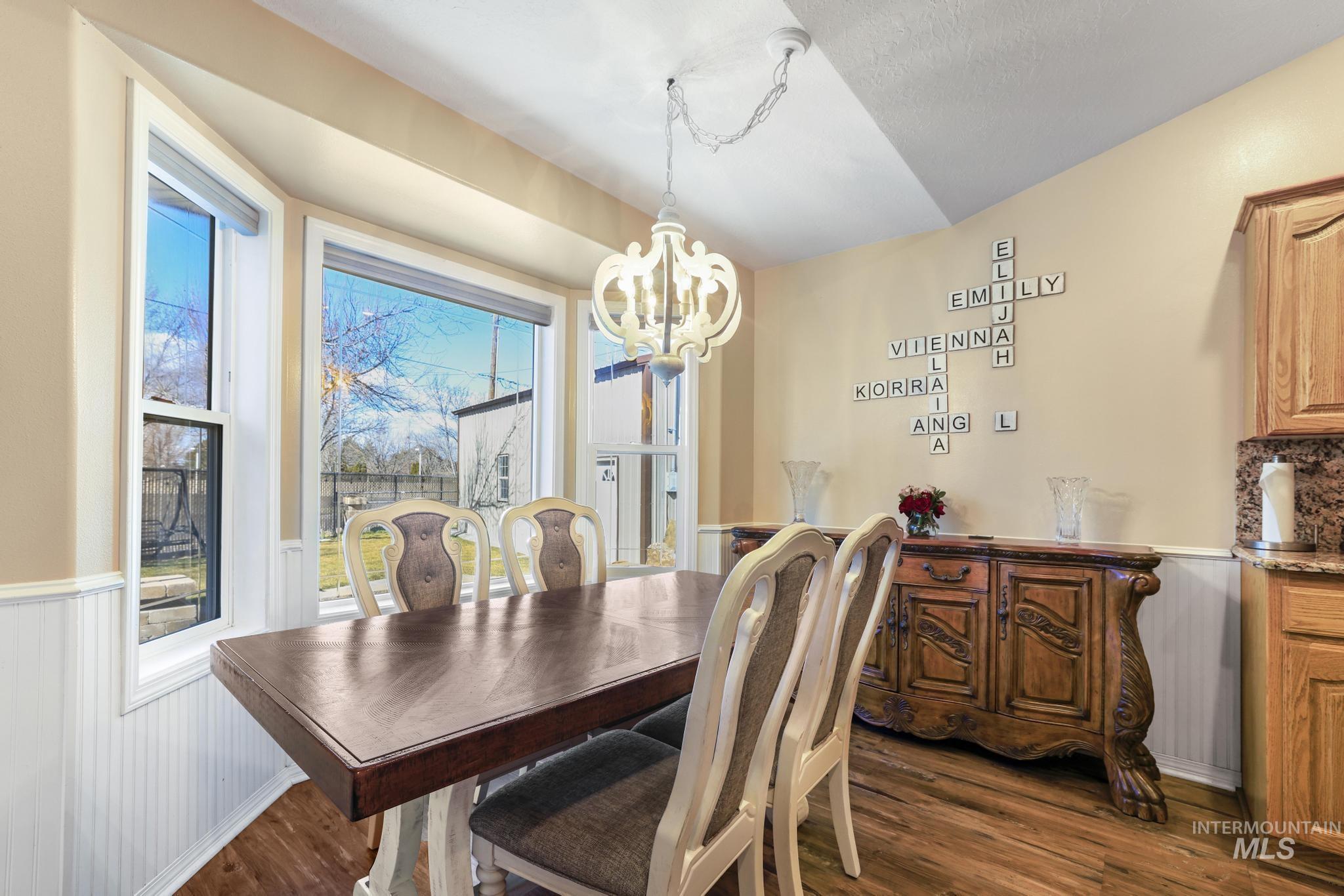 733 Beta Circle Twin Falls, ID 83301 - Photo 10 of 50 Dining room with wainscoting, a chandelier, and dark wood finished floors