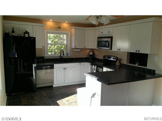 3114 Shiloh Church Road Midlothian, VA 23112 - Photo 12 of 24 a kitchen with a sink a window and stainless steel appliances