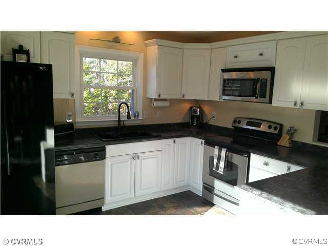 3114 Shiloh Church Road Midlothian, VA 23112 - Photo 13 of 24 a kitchen with stainless steel appliances a sink a stove a microwave a refrigerator and cabinets