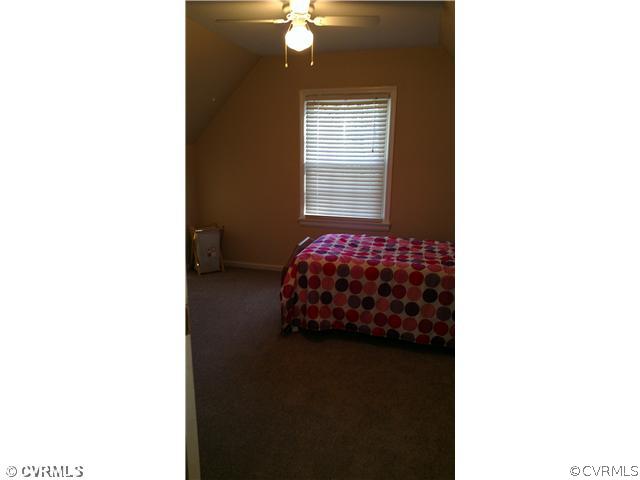 3114 Shiloh Church Road Midlothian, VA 23112 - Photo 21 of 24 a bedroom with a bed and a chandelier