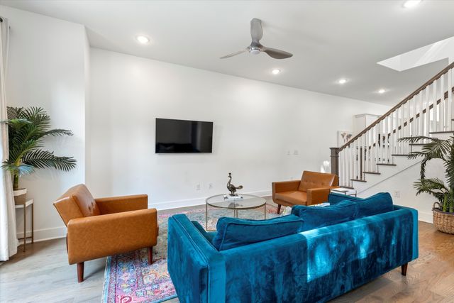 a living room with furniture and a potted plant