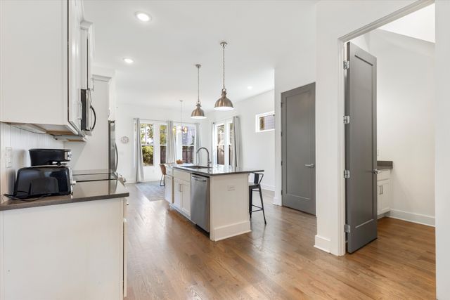 a kitchen with kitchen island a counter space and stainless steel appliances