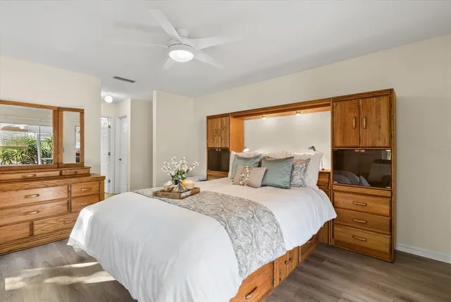 a bathroom with a bathtub shower sink vanity mirror and toilet