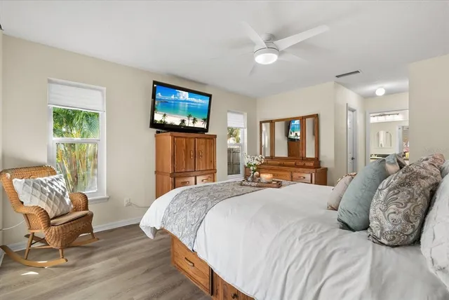 a bed sitting in a bedroom next to a window