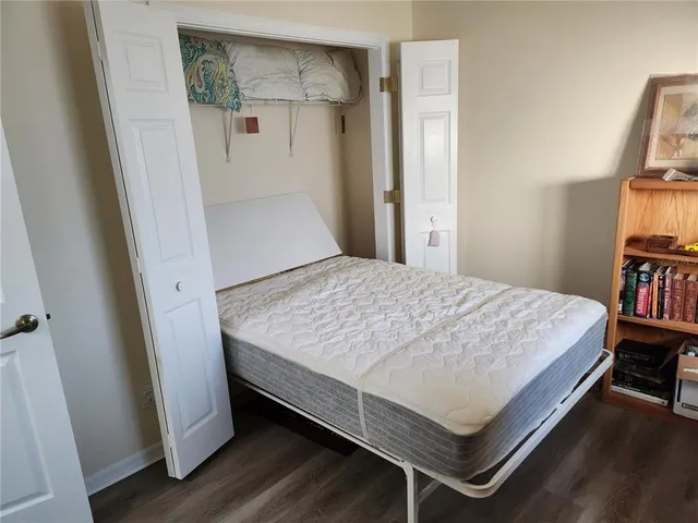 a wooden house with trees in front of it