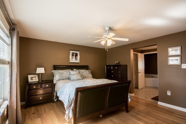 79 Huard Street Fall River, MA 02721 - Photo 12 of 30 a bedroom with a bed and wooden floor