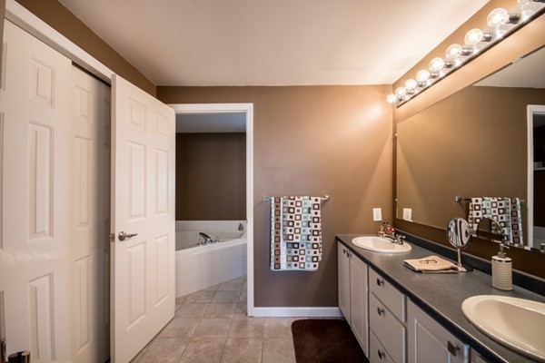 79 Huard Street Fall River, MA 02721 - Photo 13 of 30 a spacious bathroom with a granite countertop sink a toilet a mirror and shower
