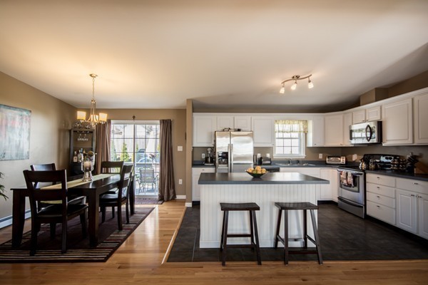 79 Huard Street Fall River, MA 02721 - Photo 2 of 30 a room with stainless steel appliances kitchen island granite countertop a dining table chairs and white cabinets