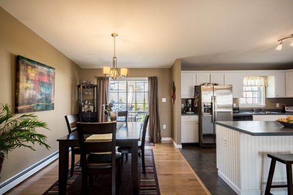 79 Huard Street Fall River, MA 02721 - Photo 7 of 30 a kitchen with refrigerator a stove dining table and chairs