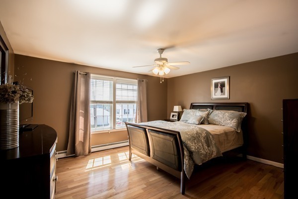 79 Huard Street Fall River, MA 02721 - Photo 10 of 30 a bedroom with a bed and a chandelier